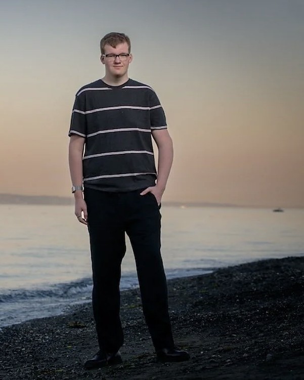 Jack standing on a Puget Sound beach at sunset
