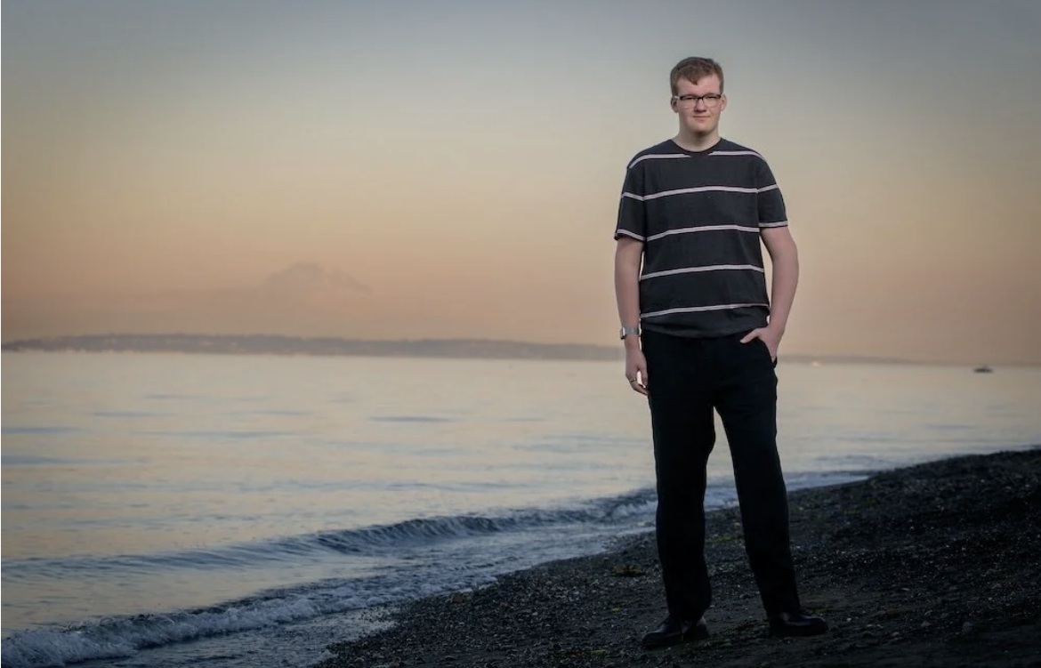 Jack on the beach at sunset, Mount Rainier behind him